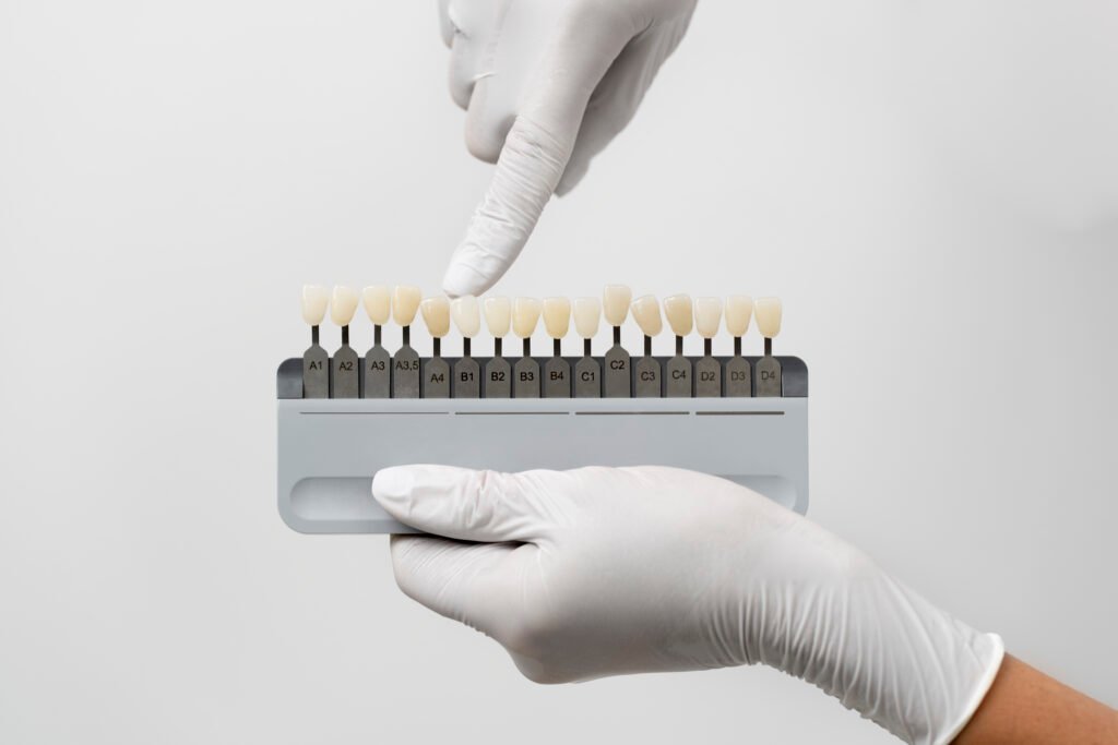 Hands holding a Porcelain Veneer Shade guide.