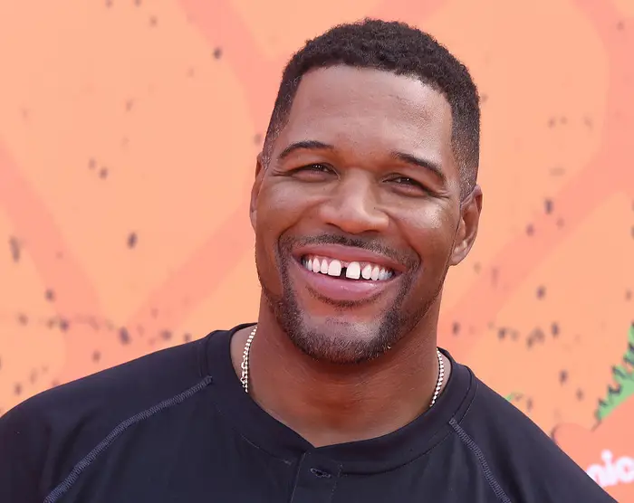 Michael Strahan smiling confidently, showcasing Michael Strahan's Signature Gap.